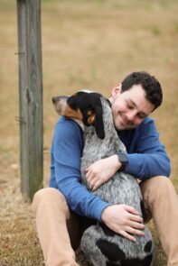 Person hugging a dog.